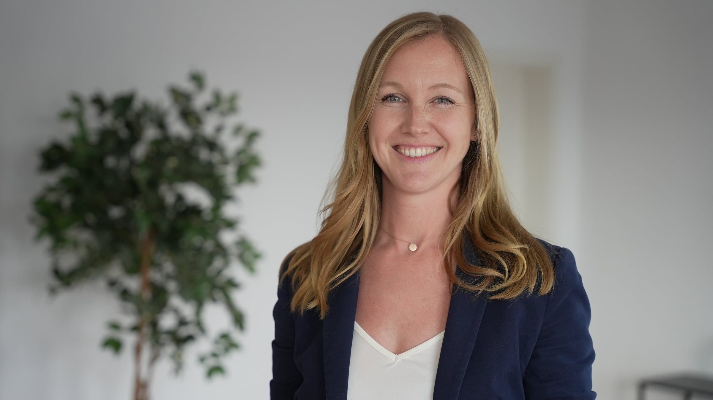 Olga Ruff, Immobilienmaklerin, lächelnd im dunkelblauen Blazer